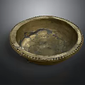 Carved Brass Bowl With Intricate Decorative Rim And Detailed Interior Patterns