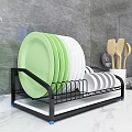 Kitchen Cabinets With Dish Rack Featuring Green White Plates And Wooden Spoons On Marble Countertop