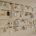 Wall with Hanging Rods Displaying Various Clothes and Fashion Bags