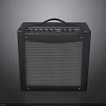 Portable Black Electric Guitar Amplifier With Control Knobs And Speaker Grille