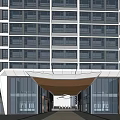 Modern Sales Office Building With Glass Facade Among High Rise Buildings And Greenery