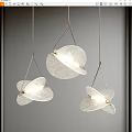 Three Modern Leaf Shaped Glass Pendant Lights With Gold Metal Frames Illuminated On Gray Wall