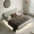 Double Bed with White Headboard Brown Pillow Gray Blanket Round Side Table and Floor Lamp
