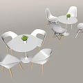White Round Dining Table And Chairs Set With Wooden Legs And Small Plant