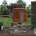 White Clothing Rack With Colorful Shirts Folded Clothes And Shoes In Outdoor Patio