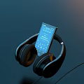 Black Portable Computer With Screen Showing Playlist And Over Ear Headphones On Dark Background