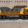 Yellow Utility Flatbed Truck Carrying Metal Cages And Stacked Goods