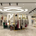 Modern Clothing Store Interior With Golden Racks Circular Display And Fashion Garments
