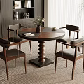 Modern Dining Space With Round Wooden Table Leather Chairs Vase Books And Potted Plant