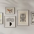 Framed Artworks in Various Styles Hanging on White Wall for Home Decor