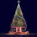 Festively Decorated Christmas Tree With Twinkling Lights Ornaments And Carousel Base Decorations