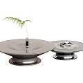 Round Modern Coffee Tables With Metal Base Smooth Surface Green Plant In Vase And Books