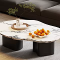 Modern Irregular Marble Top Coffee Table With Black Cylindrical Legs Green Plant And Oranges