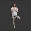 Woman Practicing Yoga Tree Pose With Hands In Prayer On Black Floor