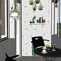 Modern Round Table And Black Chair With Geometric Pattern Wall Hanging Green Plants Decorative Shelf