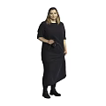 Woman in black long dress holding camera standing against gray background