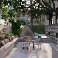 Beautiful Garden Featuring Wooden Bench Lush Green Plants Trees Purple Flowers And Hanging Lanterns