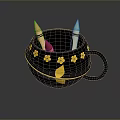 Black Mug With Gold Flower Decorations And Colorful Crayons Inside
