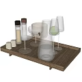 Modern Glass Cups on Wooden Tray with Glass Bottles and Green Accents