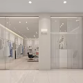 Modern Clothing Store Interior Design With Clothes On Racks Sofa Chair Reception Desk And Plant