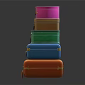Colorful Stacked Suitcases with Gold Accents Handles and Reflective Surface on Dark Background