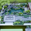 Serene Courtyard Garden Design With Pond Lush Plants Rocks And Seating Area
