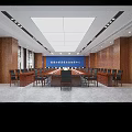 Wooden Paneled Conference Room With Rows of Tables Chairs Green Plants And Ceiling Lighting