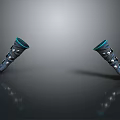 Two Dark Colored Lifestyle Accessories With Blue Edges And Metal Decorations On Smooth Black Surface