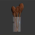 Wooden Utensil Set with Multiple Spoons Stored in Transparent Cup for Kitchen Use