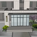 Modern Multi Story Apartment Building With Glass Windows Gray Exterior And Green Plants At Entrance