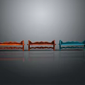 Three Red Orange Blue Benches Side By Side Arranged Against Gray Background With Reflective Floor 3d model