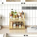 Golden Kitchen Two Tier Wire Shelf With Spices Olive Oil And Wooden Spoons On Countertop