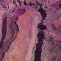 Aerial View Of Rocky Terrain With Winding Turquoise River And Colorful Canyon Landscape