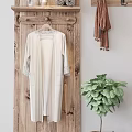 Rustic Wooden Hook Rack Holding White Robe With Lace Trim Scarf And Green Plant