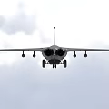 Military Camouflage Fighter Jet Flying Through Clouds With Weapon Pylons