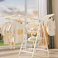 White Clothes Drying Rack Holds Hanging Yellow Heart T-shirts Baby Clothes and Folded Towels