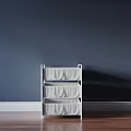 White Three Tier Storage Shelf Unit With Fabric Bins Against Navy Wall And Wood Floor