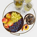 Fresh Peaches Green Purple Grapes Chocolates On Marble Table With Metal Bowl And Wine Glasses