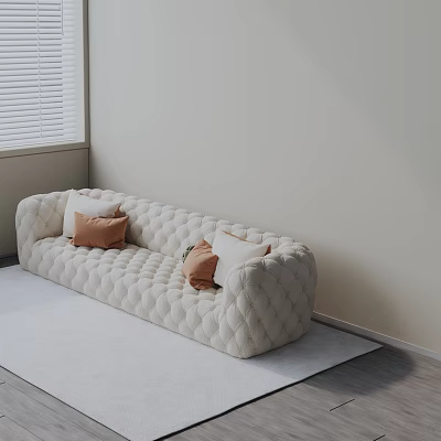 Cream Quilted Three Seater Sofa With Soft Fabric And Decorative Cushions On Light Rug 3d model