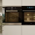 Modern Kitchen Interior Featuring Built in Ovens With White Cabinets Digital Displays And Racks