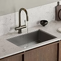 Kitchen Sink with Brushed Brass Faucet Light Gray Countertop Black Bowl and Wooden Cabinets
