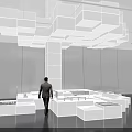 Modern Exhibition Hall With White Cube Installation Hanging From Ceiling And Blue Display Areas