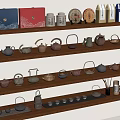 Various Tea Sets And Packages Display On Wooden Shelves With Ceramic Teapots