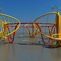 Butterfly Shaped Rotating Play Seats With Yellow Red Frames And Wooden Platforms In Garden Landscape