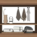 Hanging And Folded Towels Displayed On Wooden Shelf With Home Decor Items