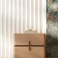 Beige Textured Bedside Table With Stacked Plates And Ceramic Bowls In Interior