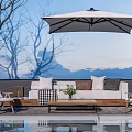 Outdoor Sofa With Cozy Pillows And Wooden Chairs Under Patio Umbrella By Pool