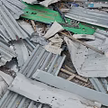 Pile of Scrap Metal Featuring Corrugated Iron Sheets Broken Panels And Wooden Pieces