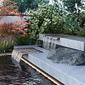 Garden Water Fountain With Cascading Waterfall Stone Pool Steps And Lush Greenery