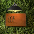 Wooden Company Sign With Green Moss Wall Background And Black Pendant Light